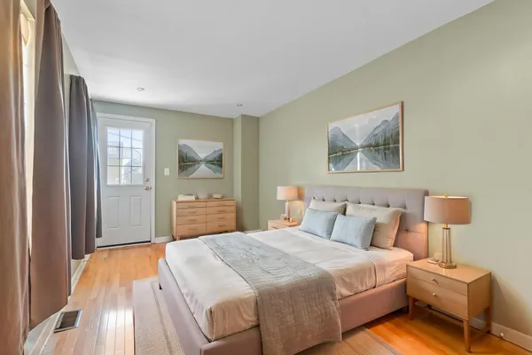 a bedroom with a bed and a painting on the wall