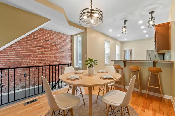 a view of a dining room with furniture wooden floor and chandelier