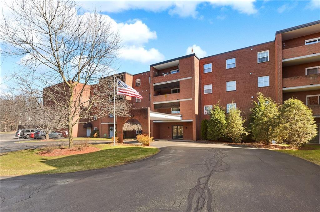 a view of building with yard street and trees