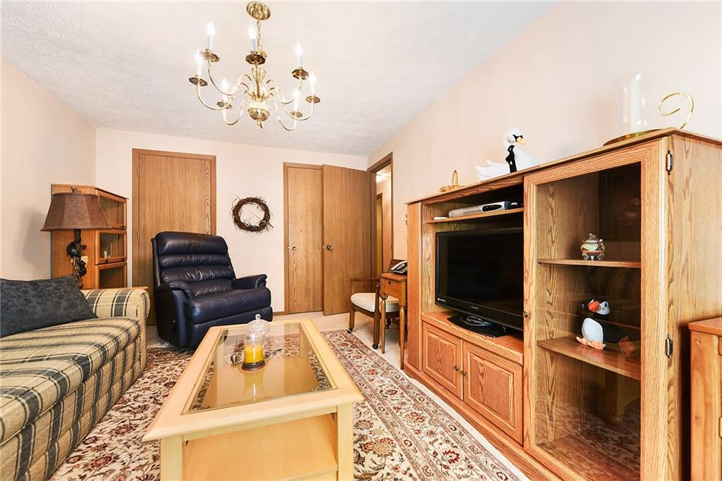 2850 Edgecliff Road, Unit 14 Lower Burrell, PA 15068 - Photo 12 of 24 a living room with furniture and a flat screen tv