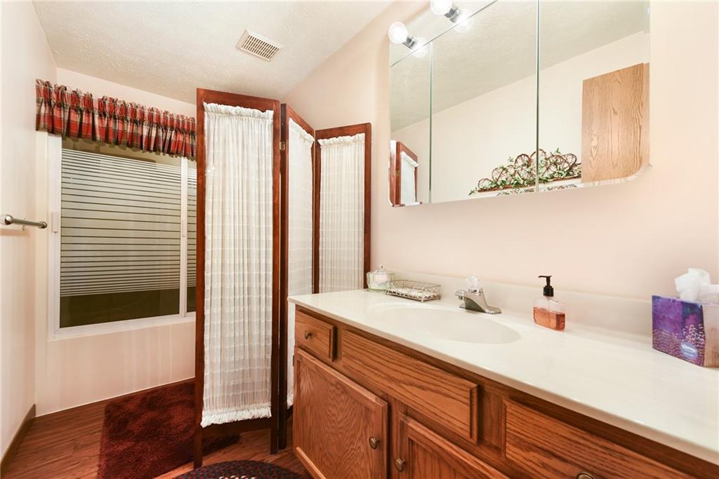 2850 Edgecliff Road, Unit 14 Lower Burrell, PA 15068 - Photo 18 of 24 a bathroom with a sink and a mirror
