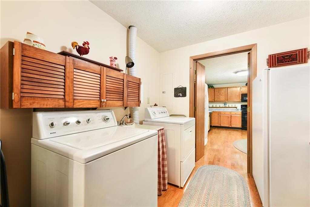 2850 Edgecliff Road, Unit 14 Lower Burrell, PA 15068 - Photo 19 of 24 a view of washer and dryer with bathroom in the background