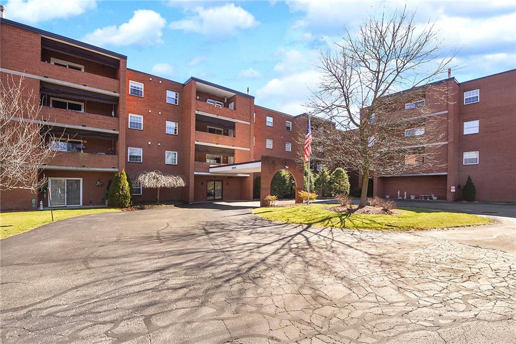 2850 Edgecliff Road, Unit 14 Lower Burrell, PA 15068 - Photo 2 of 24 a view of a house with a swimming pool
