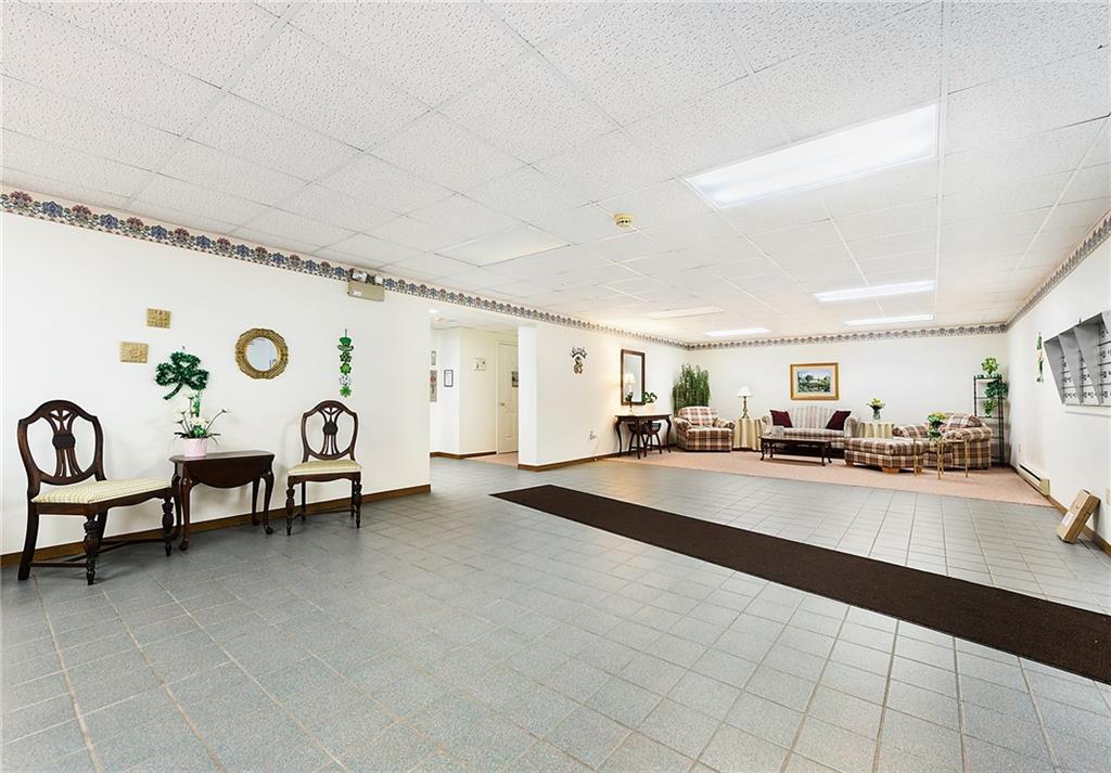 2850 Edgecliff Road, Unit 14 Lower Burrell, PA 15068 - Photo 22 of 24 a living room with furniture and a table