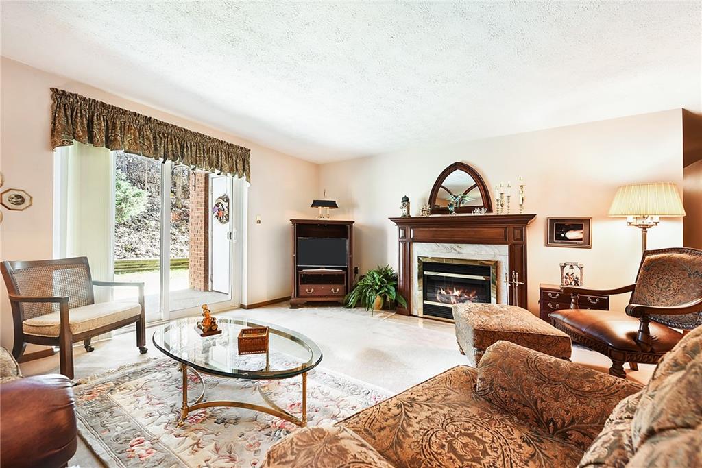 2850 Edgecliff Road, Unit 14 Lower Burrell, PA 15068 - Photo 3 of 24 a living room with furniture and a fireplace