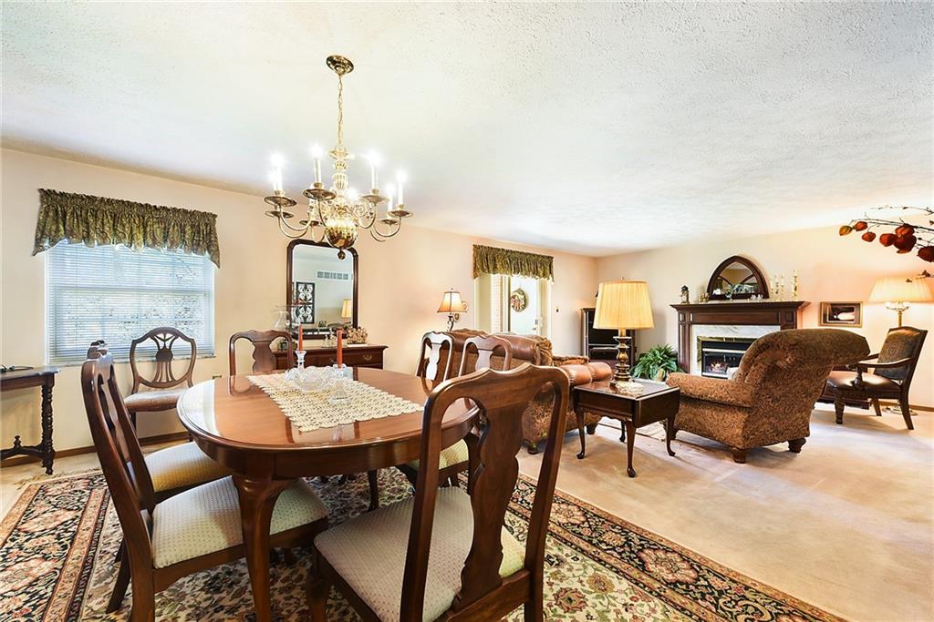 2850 Edgecliff Road, Unit 14 Lower Burrell, PA 15068 - Photo 10 of 24 a view of a dining room with furniture window and wooden floor