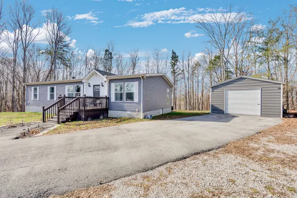 a view of a house with a yard and garage