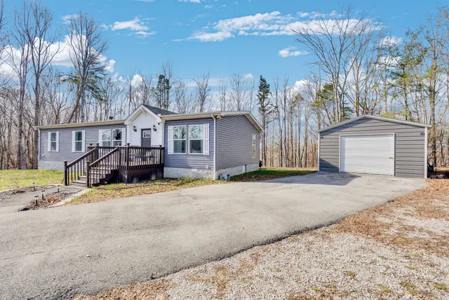 a view of a house with a yard and garage