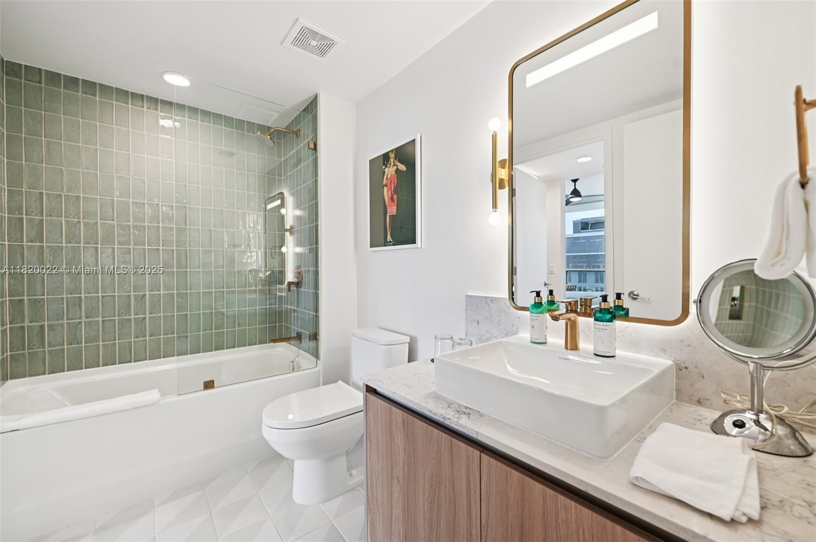 159 Northeast 6th Street, Unit 3407 Miami, FL 33132 - Photo 4 of 16 a bathroom with a sink a toilet and shower