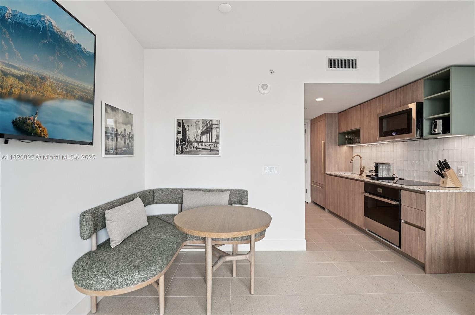 159 Northeast 6th Street, Unit 3407 Miami, FL 33132 - Photo 9 of 16 a kitchen with stainless steel appliances granite countertop a sink and a refrigerator