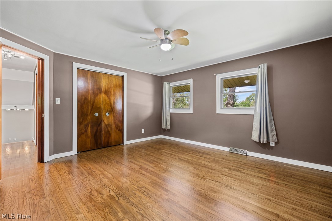 17583 Shurmer Road Strongsville, OH 44136 - Photo 28 of 50 Room featuring wood-finish flooring, two windows, and a ceiling fan