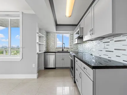 a view of a terrace with furniture and a floor to ceiling window
