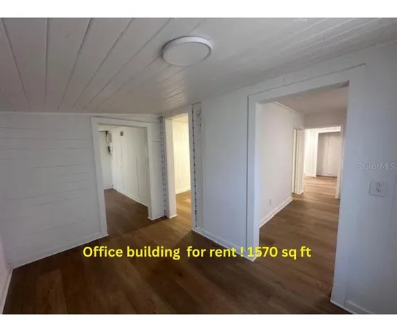 a view of a hall with wooden floor