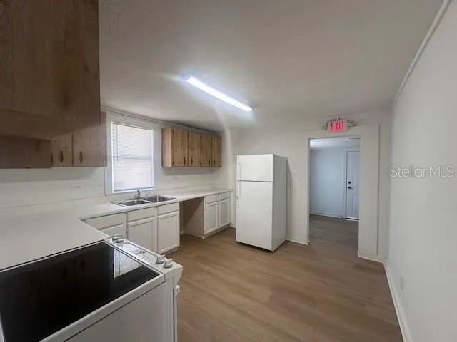 a kitchen with a refrigerator and a sink