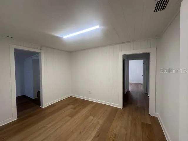 a view of hallway with wooden floor