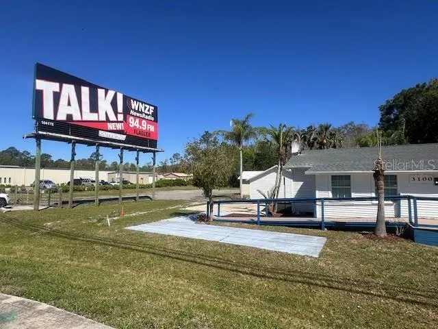 a swimming pool with outdoor seating and yard