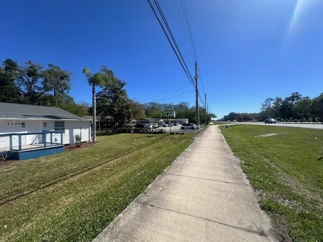a view of a street with a building in the background