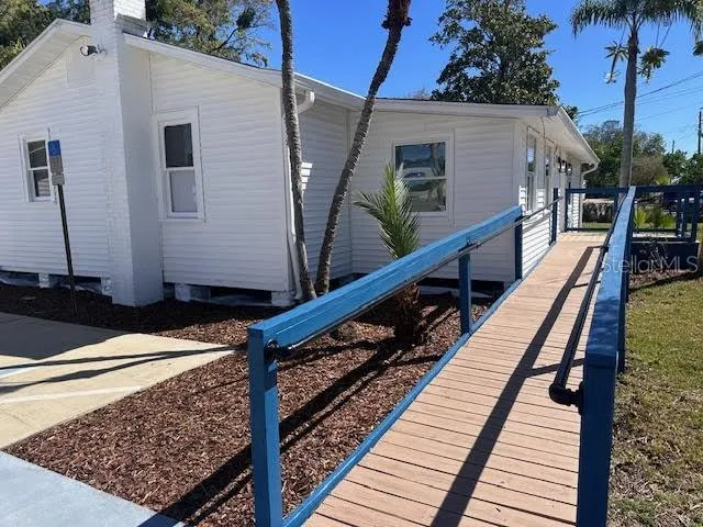 a view of a balcony with wooden floor and fence