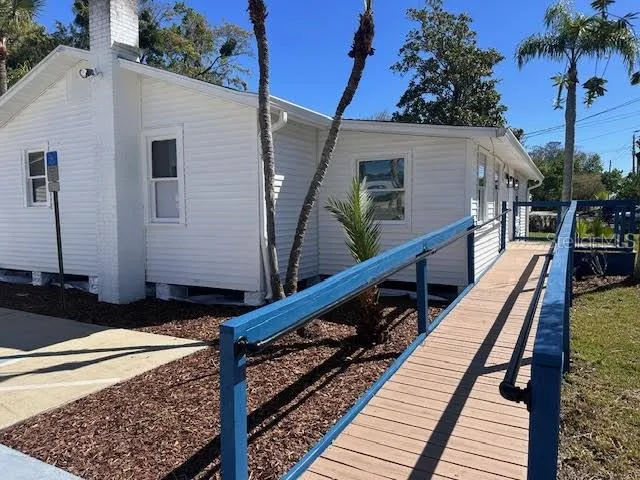a balcony view with a large window and potted plants