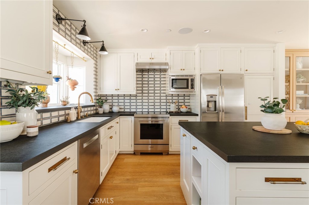 429 20th Street Manhattan Beach, CA 90266 - Photo 13 of 57 a kitchen with stainless steel appliances granite countertop a sink and cabinets