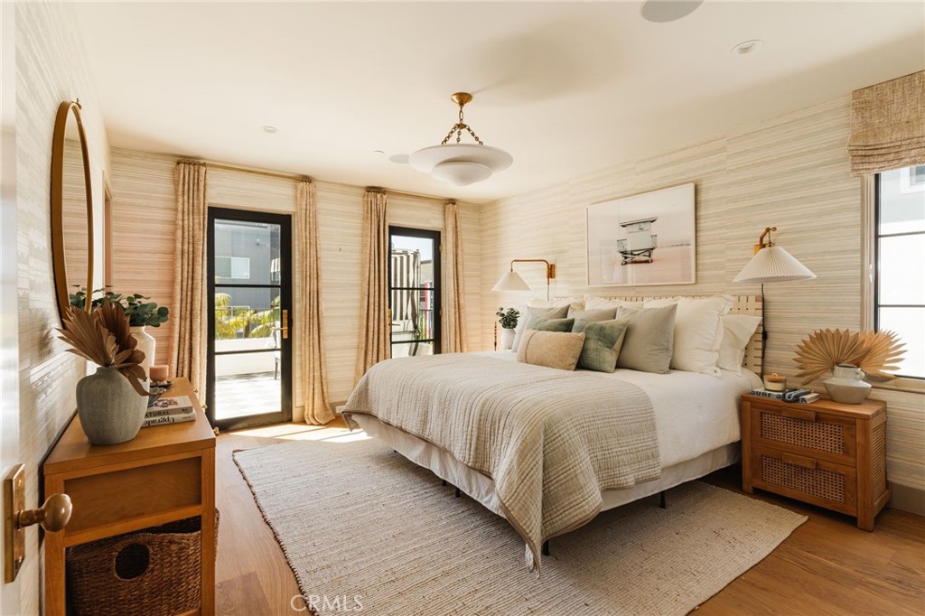 429 20th Street Manhattan Beach, CA 90266 - Photo 18 of 57 a spacious bedroom with a bed and wooden floor