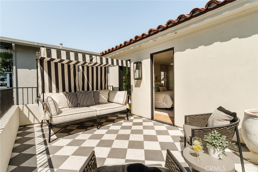 429 20th Street Manhattan Beach, CA 90266 - Photo 21 of 57 a balcony with wooden floor and outdoor seating