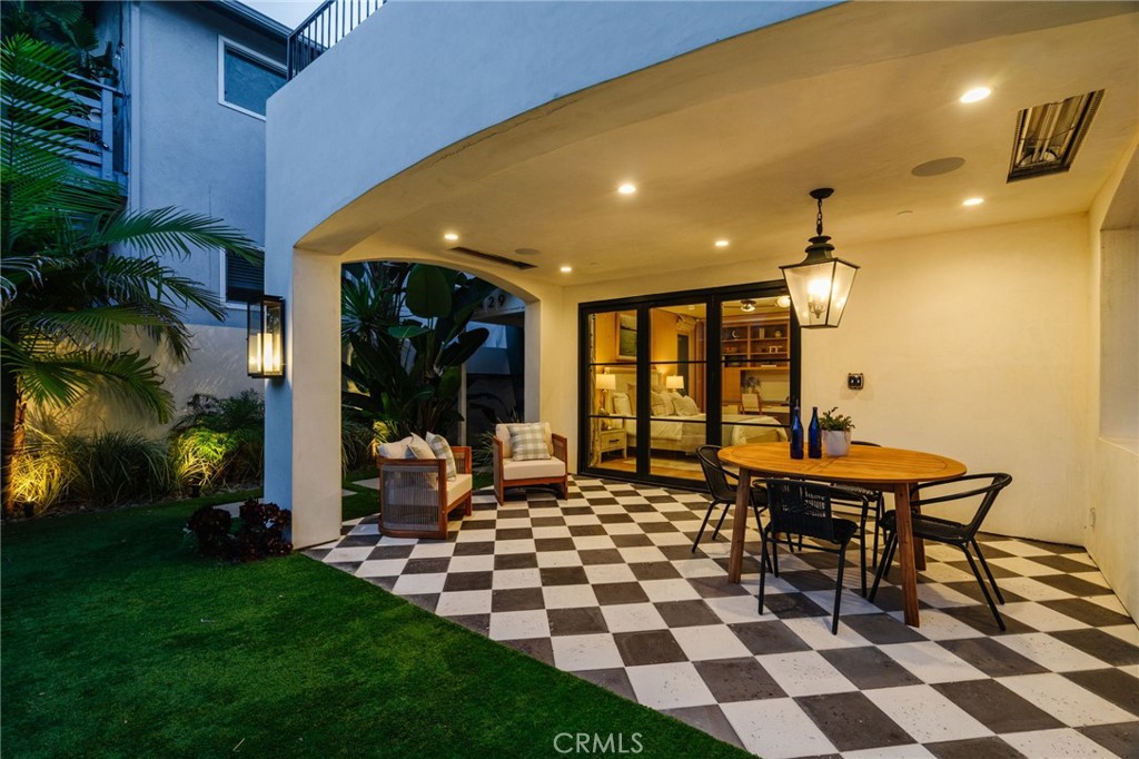 429 20th Street Manhattan Beach, CA 90266 - Photo 55 of 57 a living room with a table chairs and a yard