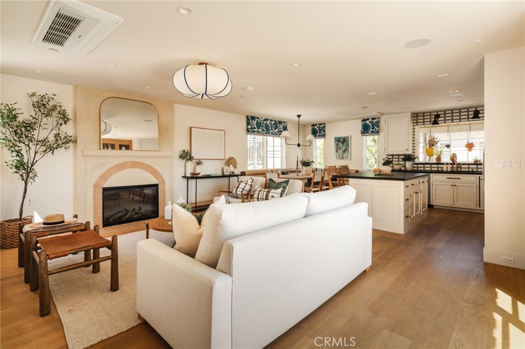 429 20th Street Manhattan Beach, CA 90266 - Photo 8 of 57 a living room with furniture a fireplace and a chandelier