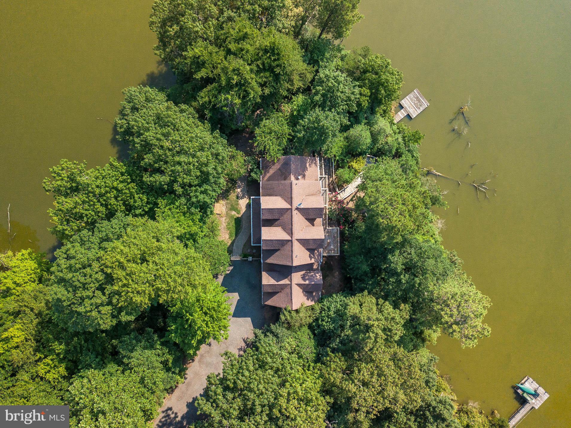 12756 Bullet Bend Road Lusby, MD 20657 - Photo 2 of 56 an aerial view of a house with swimming pool and garden space