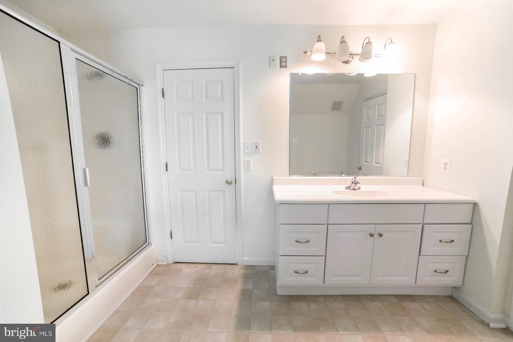 12756 Bullet Bend Road Lusby, MD 20657 - Photo 16 of 56 a bathroom with a double vanity sink mirror and
