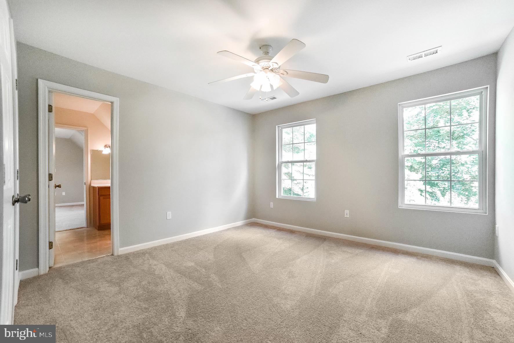 12756 Bullet Bend Road Lusby, MD 20657 - Photo 17 of 56 an empty room with windows and fan