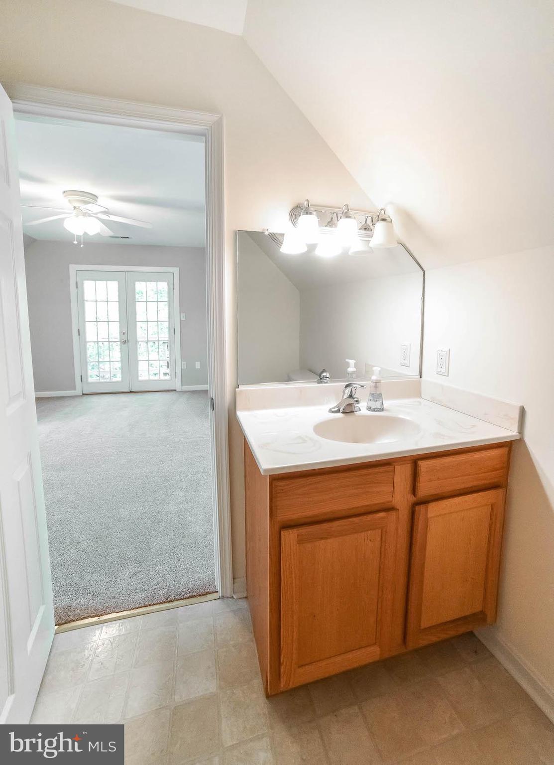 12756 Bullet Bend Road Lusby, MD 20657 - Photo 19 of 56 a bathroom with a sink and a mirror