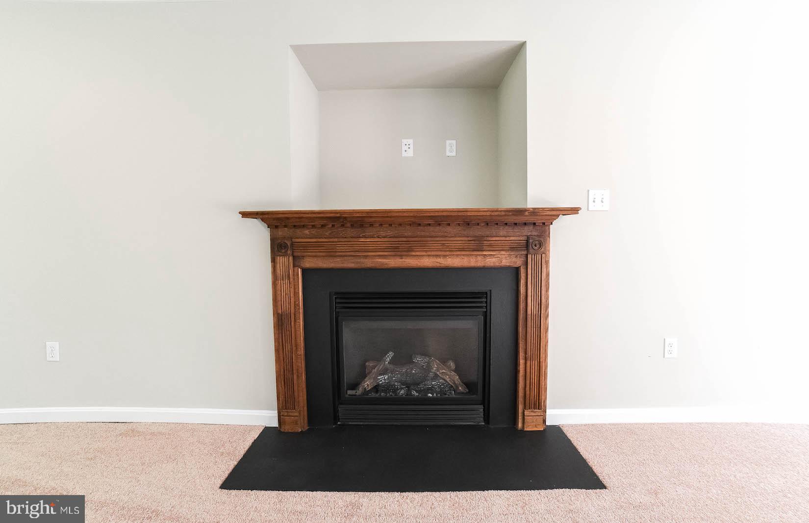 12756 Bullet Bend Road Lusby, MD 20657 - Photo 25 of 56 a living room with a fireplace