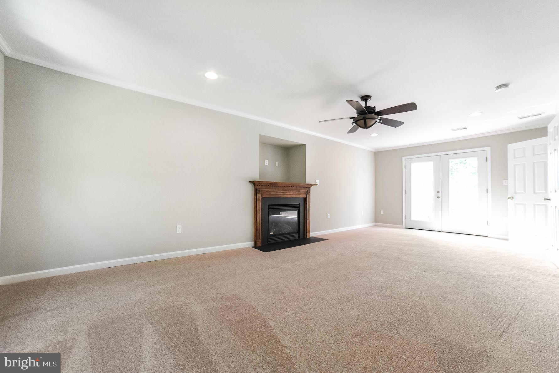 12756 Bullet Bend Road Lusby, MD 20657 - Photo 26 of 56 a view of a livingroom with a ceiling fan and window