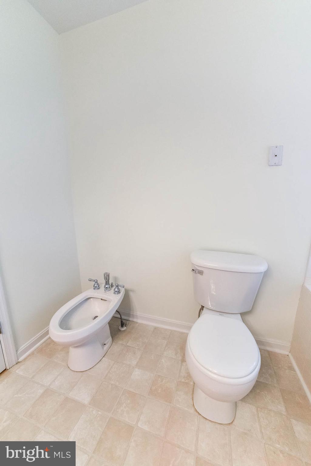 12756 Bullet Bend Road Lusby, MD 20657 - Photo 30 of 56 a white toilet sitting next to a white cabinet