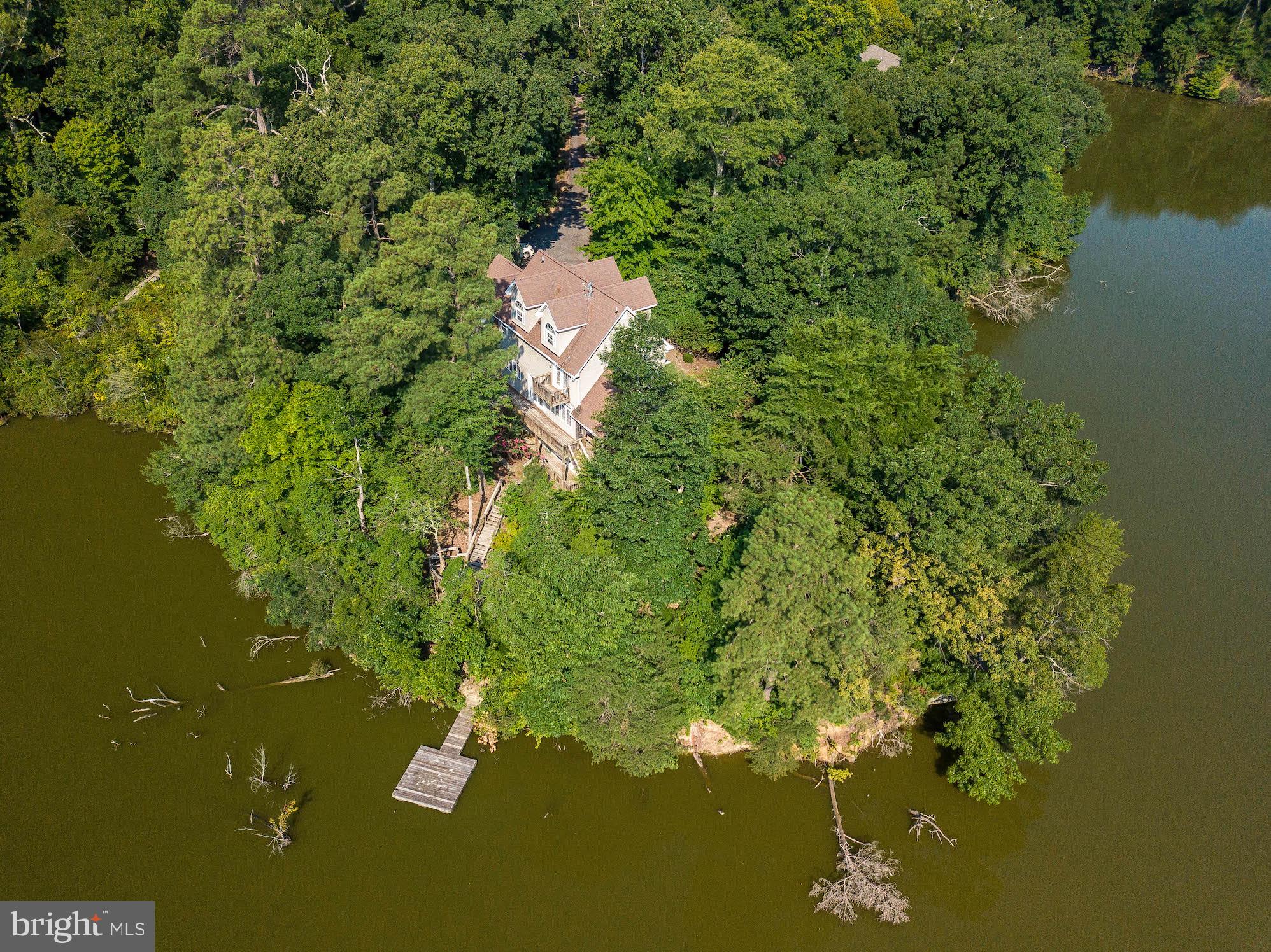 12756 Bullet Bend Road Lusby, MD 20657 - Photo 4 of 56 a view of a lake with a house