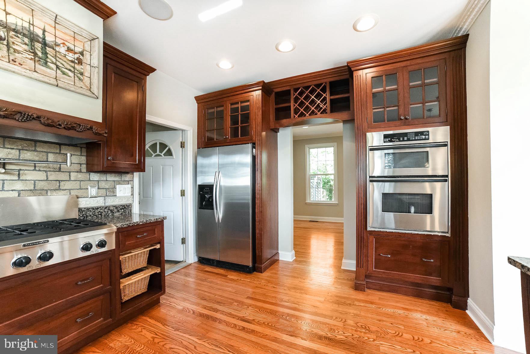 12756 Bullet Bend Road Lusby, MD 20657 - Photo 41 of 56 a kitchen with stainless steel appliances granite countertop a refrigerator and a stove