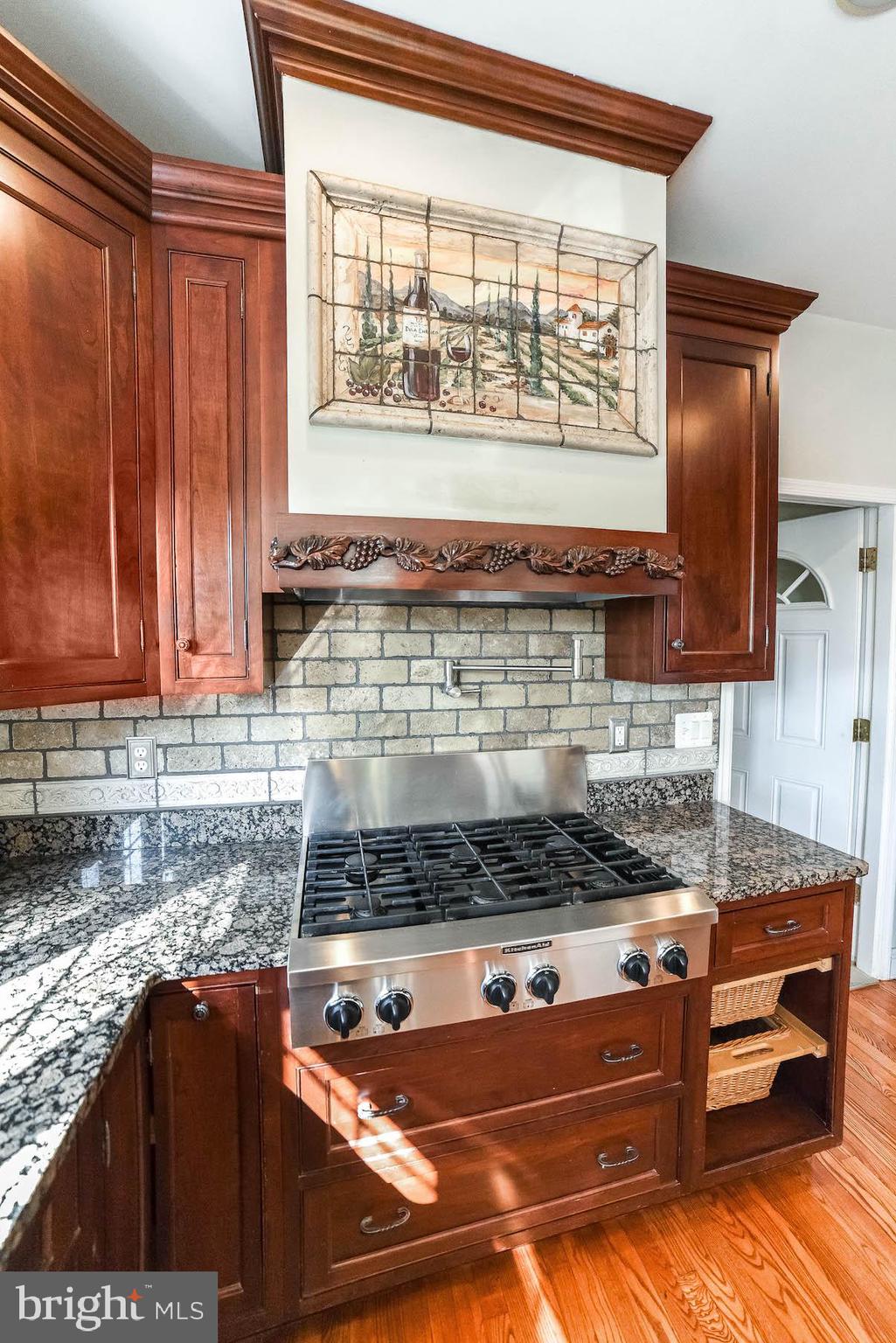 12756 Bullet Bend Road Lusby, MD 20657 - Photo 42 of 56 a kitchen with stainless steel appliances granite countertop a stove a sink and a microwave