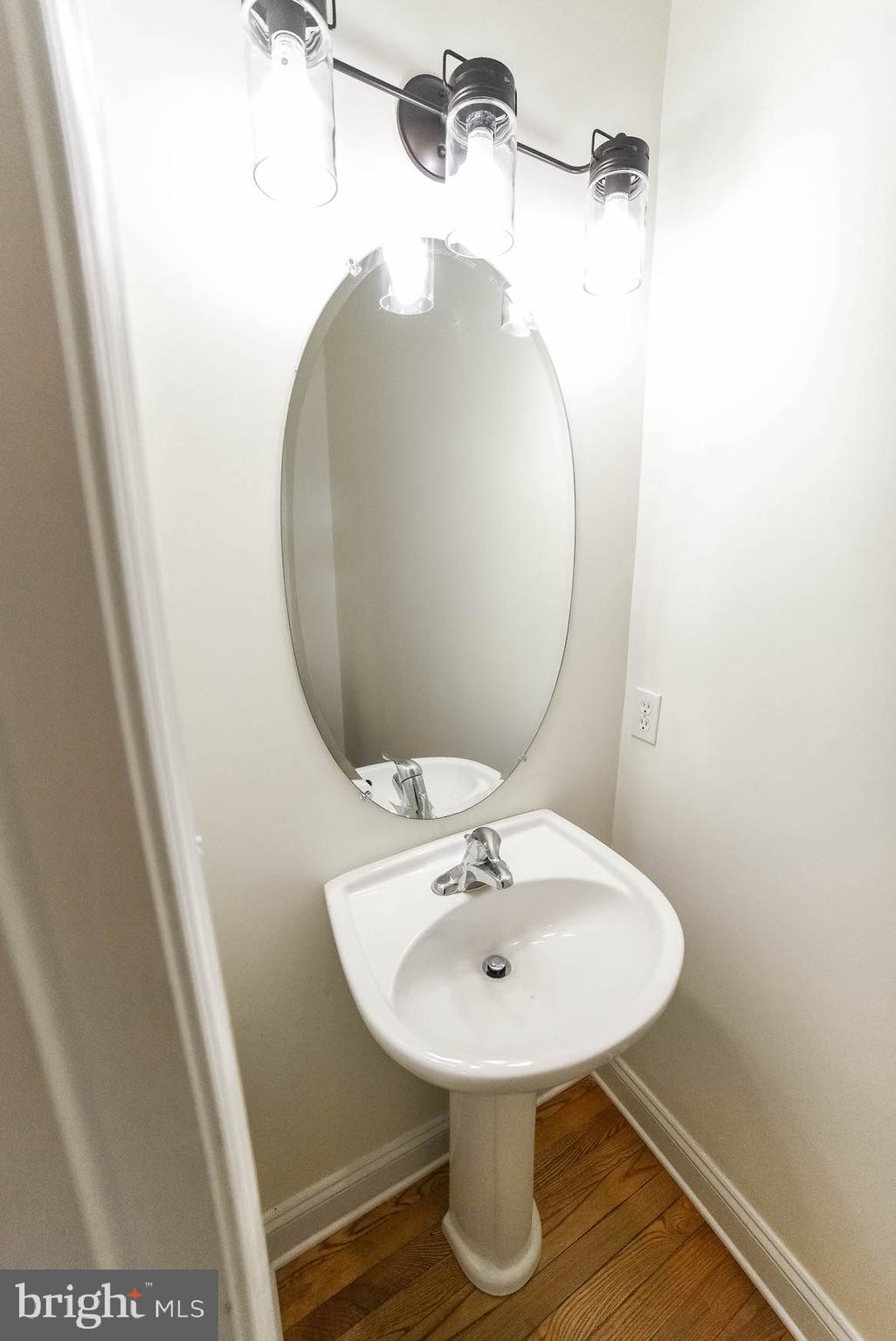 12756 Bullet Bend Road Lusby, MD 20657 - Photo 45 of 56 a bathroom with a sink and mirror