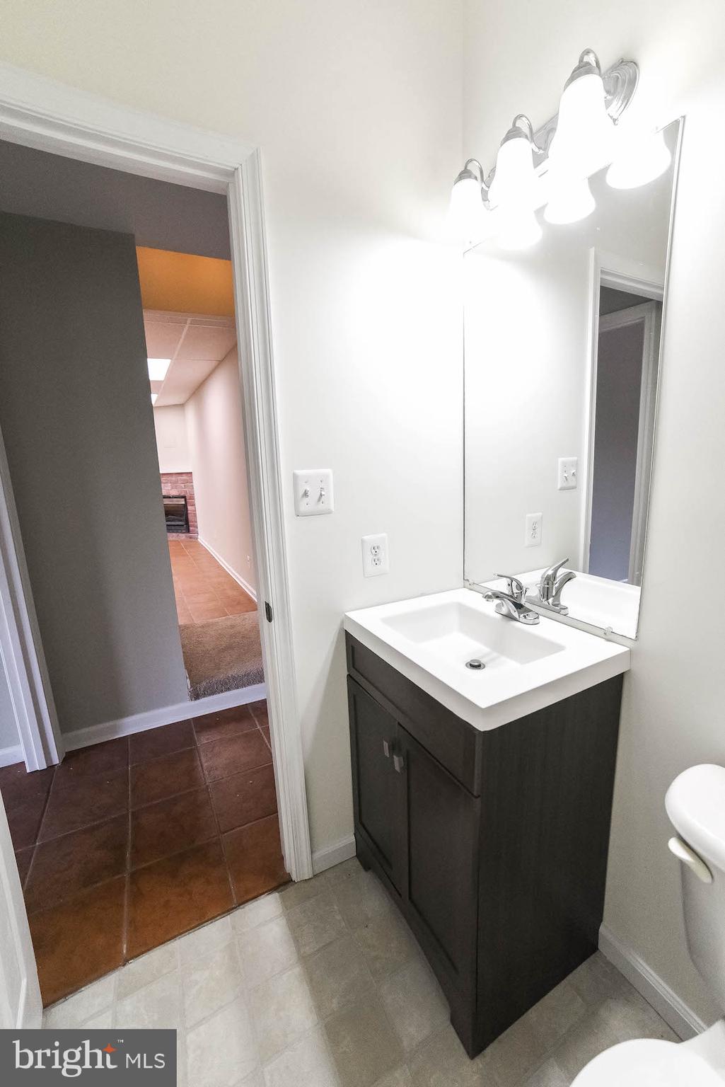 12756 Bullet Bend Road Lusby, MD 20657 - Photo 47 of 56 a bathroom with a sink and a mirror