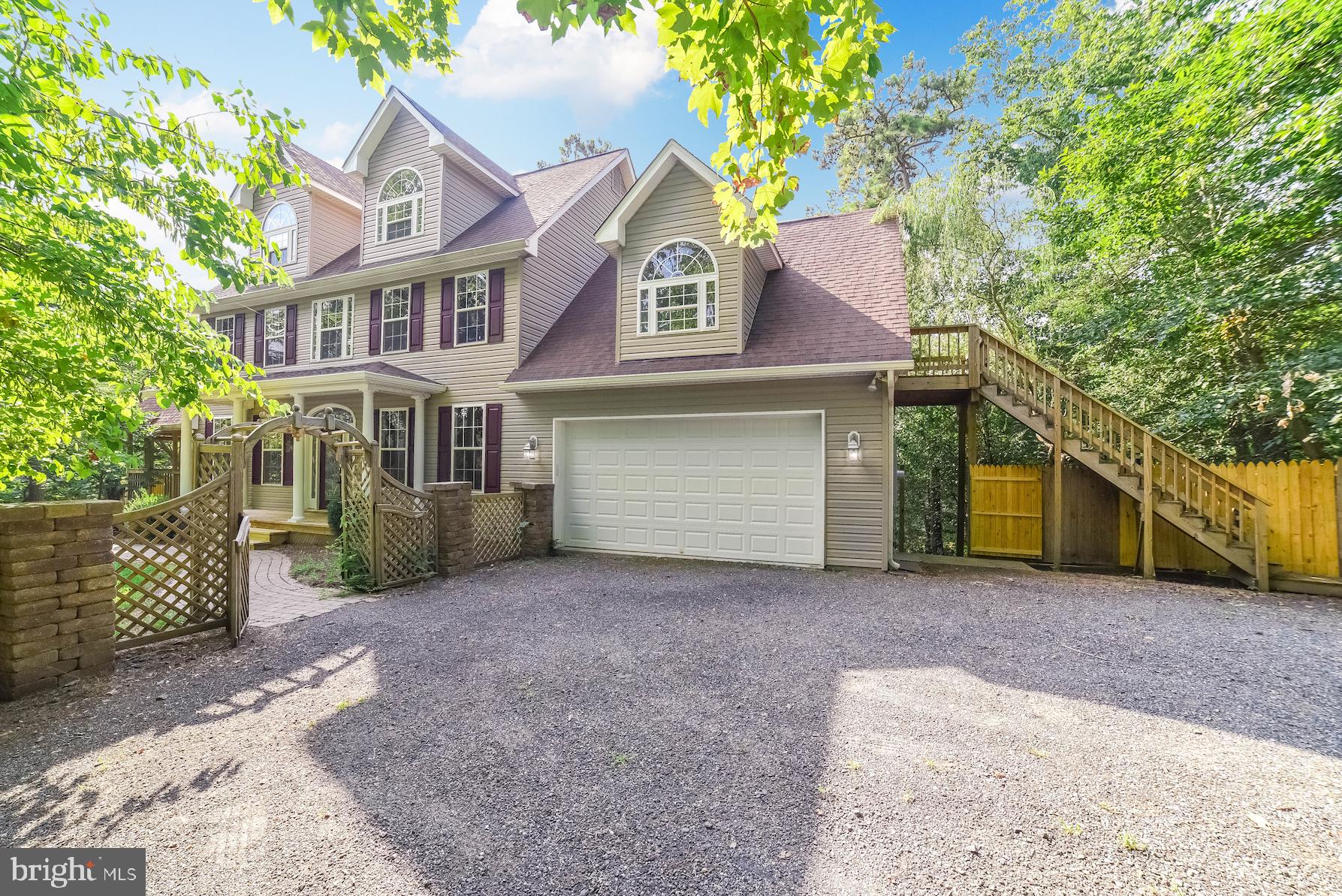 12756 Bullet Bend Road Lusby, MD 20657 - Photo 55 of 56 a view of a house with a yard and large tree