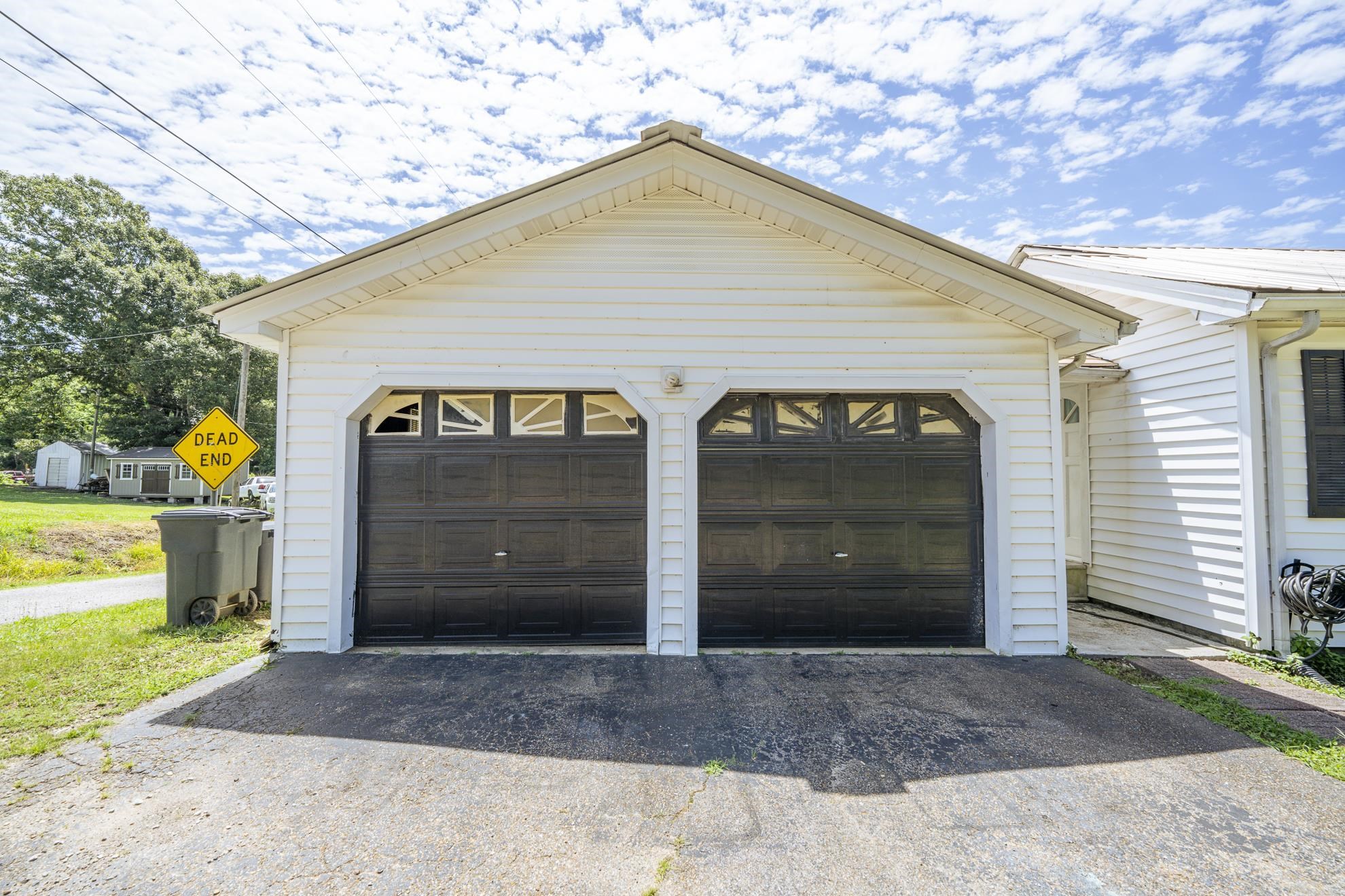 369 Bethel-Purdy Road Bethel Springs, TN 38315 - Photo 18 of 19 Two-car garage featuring dark-colored doors with decorative window inserts