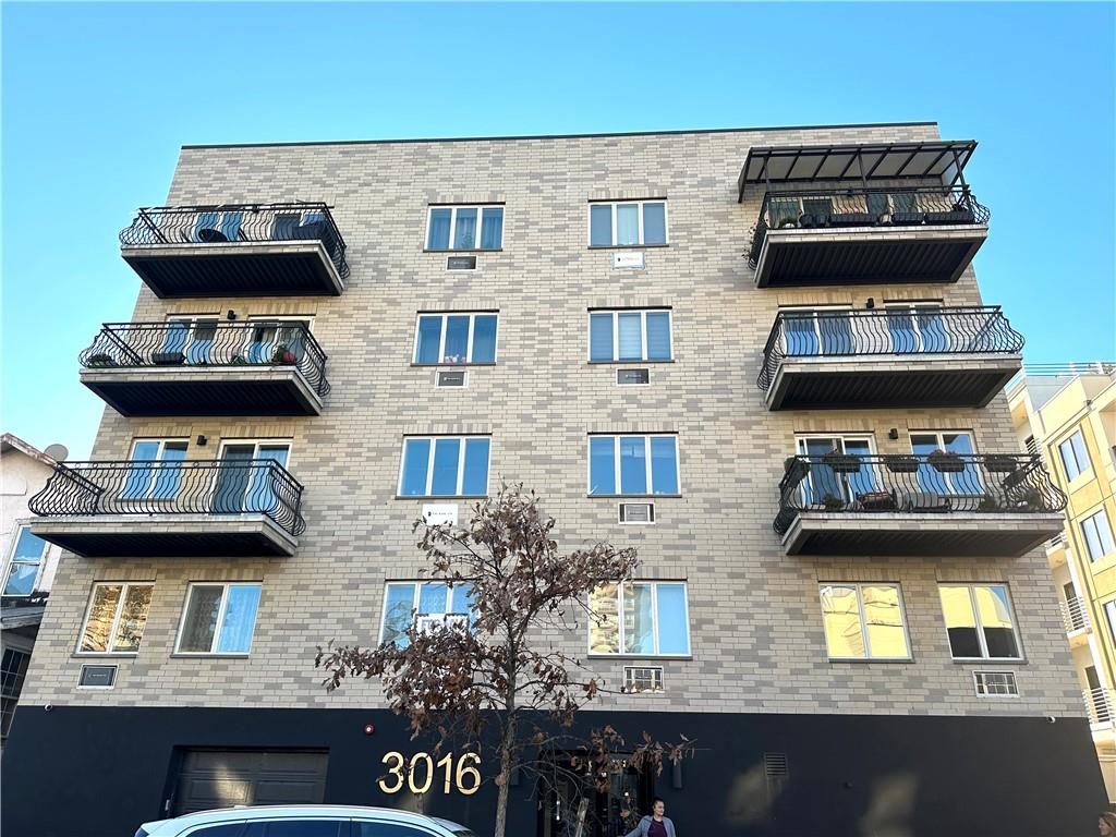 3016 Brighton 5th Street, Unit 1A Brooklyn, NY 11235 - Photo 1 of 15 a view of a brick house with many windows