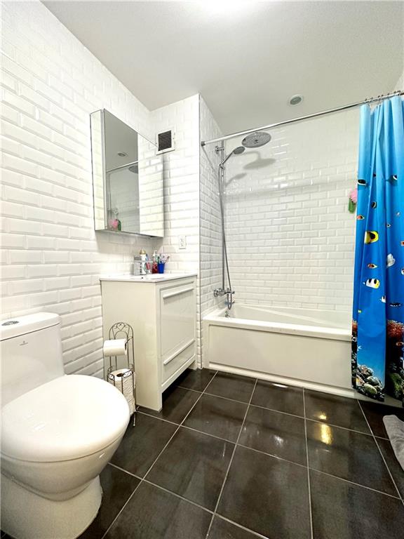 3016 Brighton 5th Street, Unit 1A Brooklyn, NY 11235 - Photo 11 of 15 a bathroom with a sink toilet and shower