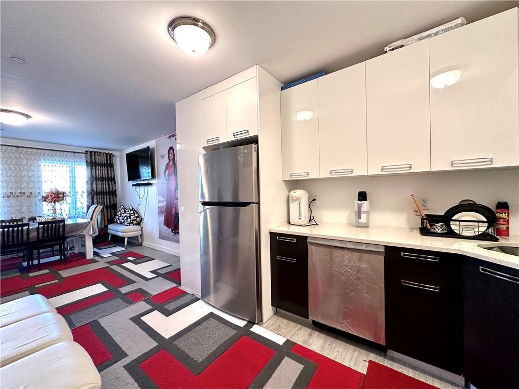 3016 Brighton 5th Street, Unit 1A Brooklyn, NY 11235 - Photo 6 of 15 a kitchen with refrigerator and sink