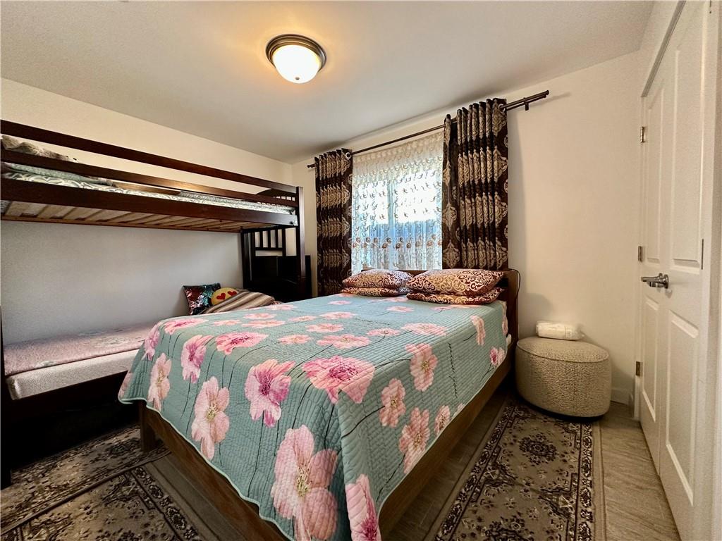 3016 Brighton 5th Street, Unit 1A Brooklyn, NY 11235 - Photo 9 of 15 a bedroom with a bed and a window