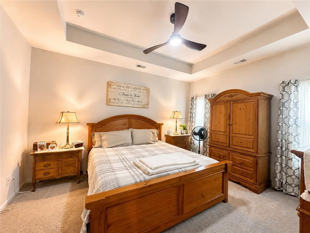 53 Bennett Way Rome, GA 30161 - Photo 17 of 42 a bedroom with a bed and a chandelier