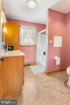 a room with a stove top oven a sink and a window