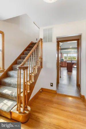 a view of entryway and hall with wooden floor