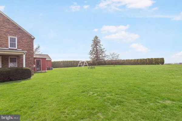 a house with a big yard and large trees